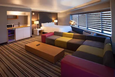 a hotel room with a bed and a couch at Hotel Huntington Beach in Huntington Beach