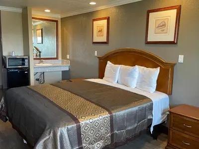a hotel room with a bed and a sink at Arlington Inn in Riverside