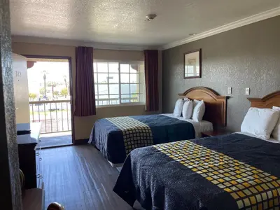 a hotel room with two beds and a window at Arlington Inn in Riverside