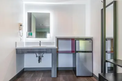 a bathroom with a sink and a mirror at Solo Motel Broadway in Los Angeles
