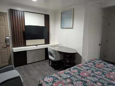 a hotel room with a bed and a desk and a television at Airport Motel - Inglewood in Inglewood