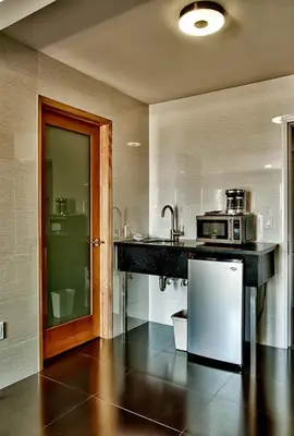 a kitchen with a sink and a microwave at Grandview Inn in Hermosa Beach