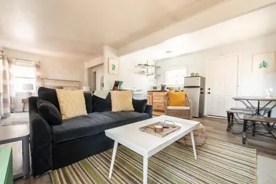 a living room with a black couch and a table at Lakewood Cabins in Big Bear Lake