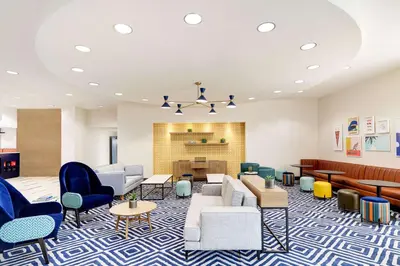 a lobby with couches and chairs and a fireplace at Hotel Lulu, BW Premier Collection in Anaheim