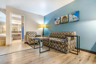 a living room with two chairs and a table at Hotel Hacienda at Ontario Ranch in Ontario