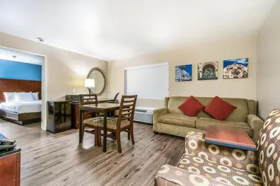 a living room with a couch and a table at Hotel Hacienda at Ontario Ranch in Ontario