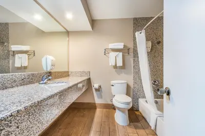 a bathroom with a toilet and a sink and a shower at Hotel Hacienda at Ontario Ranch in Ontario