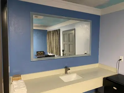 a bathroom with a sink and a mirror at Golden West Manor Motel in Los Angeles
