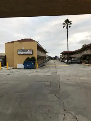 an empty parking lot in front of a store at Los Angeles Inn & Suites - LAX in Los Angeles