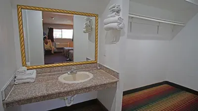 a bathroom with a sink and a mirror at Los Angeles Inn & Suites - LAX in Los Angeles