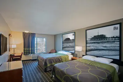 a hotel room with two beds and a flat screen tv at The Hotel 39 in Westminster