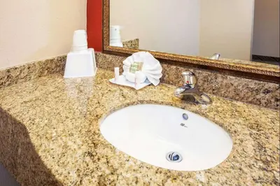 a bathroom counter with a sink and a mirror at The Hotel 39 in Westminster