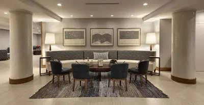 a dining room with a table and chairs at Redondo Beach Hotel, Tapestry Collection by Hilton in Redondo Beach