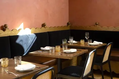 a row of tables in a restaurant with empty glasses at Short Stories Hotel Near The Grove in Los Angeles