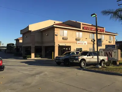 two cars parked in front of a building at Mountain Inn in Ontario