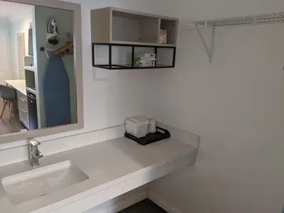 a bathroom counter with a sink and a mirror at Ramada by Wyndham Redondo Beach in Redondo Beach
