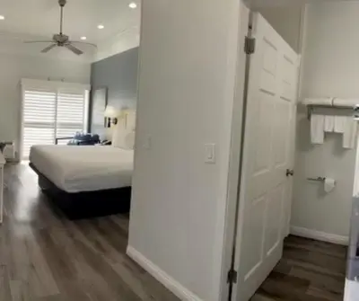 a bedroom with a bed and a white door at Ramada by Wyndham Redondo Beach in Redondo Beach