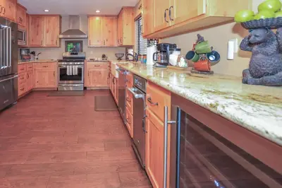 a kitchen with wooden cabinets and a counter top at The Lodge at Snow Summit Home in Big Bear Lake