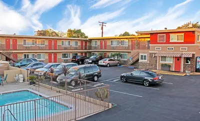 a parking lot with cars parked in front of a building at Friendly Hills Inn - Whittier, Los Angeles in Whittier