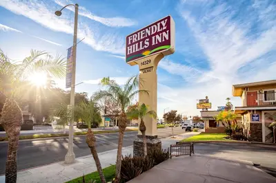 a sign for a hotel in front of a street at Friendly Hills Inn - Whittier, Los Angeles in Whittier