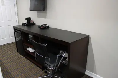 a black desk with a chair in a room at Friendly Hills Inn - Whittier, Los Angeles in Whittier