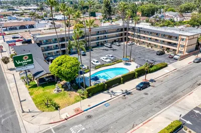 an aerial view of a hotel with a parking lot at Vagabond Inn Whittier in Whittier
