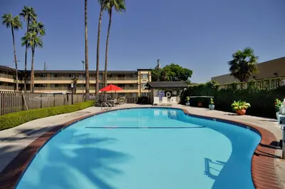 a large swimming pool in front of a building at Vagabond Inn Whittier in Whittier