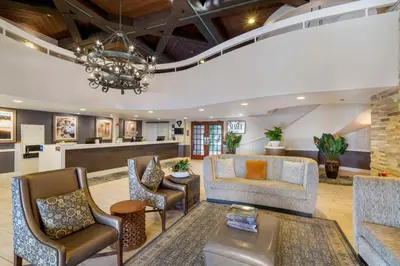 a lobby with a couch chairs and a table at Best Western Plus Carpinteria Inn in Carpinteria