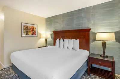 a hotel room with a bed and a table with a lamp at Best Western Plus Carpinteria Inn in Carpinteria