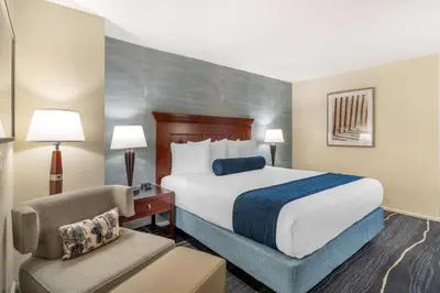 a hotel room with a bed and a chair at Best Western Plus Carpinteria Inn in Carpinteria
