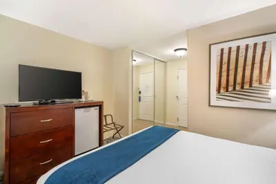 a bedroom with a bed and a flat screen tv at Best Western Plus Carpinteria Inn in Carpinteria
