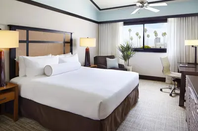 a hotel room with a large bed and a desk at Ambrose Hotel in Los Angeles