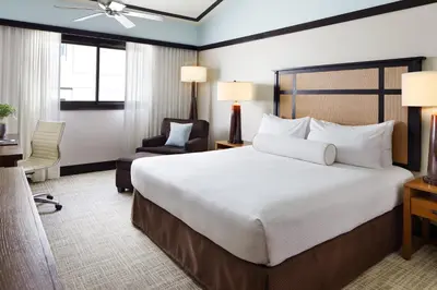 a hotel room with a large bed and a chair at Ambrose Hotel in Los Angeles