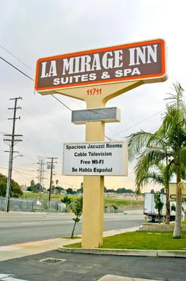 a sign for a la mirage inn suites and spa at La Mirage Inn LAX Airport in Los Angeles