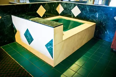 a bathroom with a green and white counter top at La Mirage Inn LAX Airport in Los Angeles