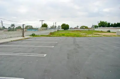 an empty parking lot with an empty parking lot at La Mirage Inn LAX Airport in Los Angeles