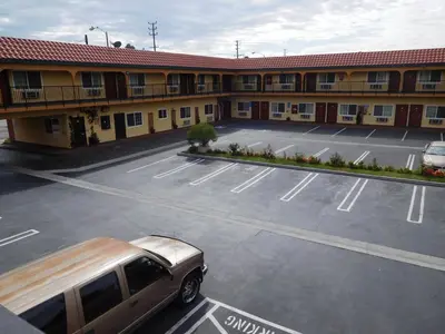 an empty parking lot in front of a motel at Diamond Inn in Inglewood