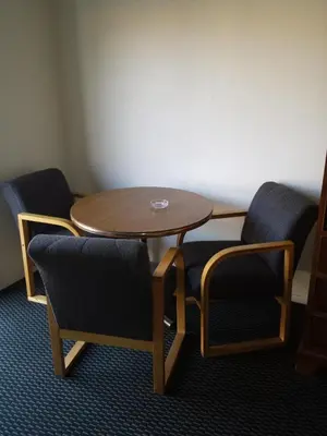 a wooden table and two chairs and a table and chairs at New Kansan Motel in Rancho Cucamonga