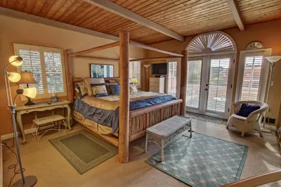 a bedroom with a bed in a room with windows at 