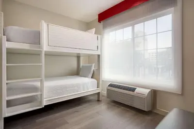 a bedroom with bunk beds and a window at Ramada by Wyndham Anaheim Convention Center in Anaheim