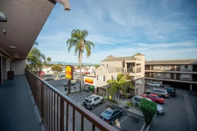 a balcony with a view of a parking lot with cars at Casa Bella Inn- Huntington Park in Huntington Park