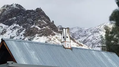 a house in front of a snow covered mountain at Sacred Mtn River Suites in Kernville