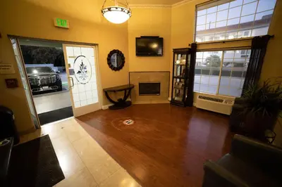a living room with a room with a car on the floor at Mid City Inn & Suites Pico Rivera in Pico Rivera