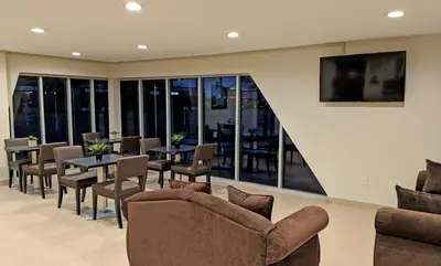 a dining room with tables and chairs at Epic Hotel in Pico Rivera
