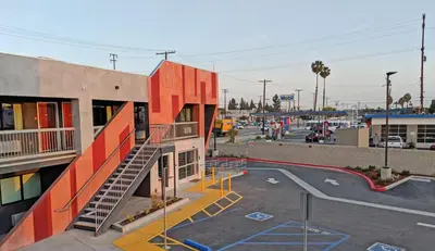 a building with a staircase next to a parking lot at Epic Hotel in Pico Rivera
