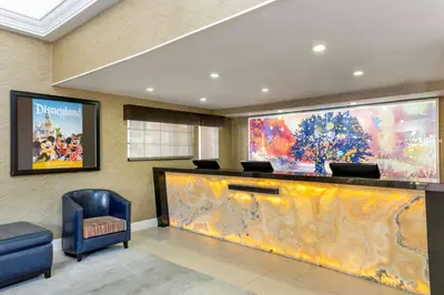 a lobby with a large screen in a building at Best Western Plus Raffles Inn & Suites in Anaheim