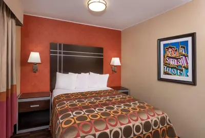 a bedroom with a large bed in a hotel room at Best Western Plus Raffles Inn & Suites in Anaheim