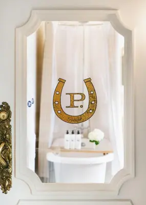 a bathroom mirror with a monogrammed mirror over a sink at Palihotel Melrose in Los Angeles