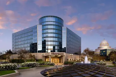 a large glass building with a fountain in front of it at Sheraton Cerritos in Buena Park
