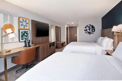 a hotel room with two beds and a desk at Holiday Inn Ontario Airport - California by IHG in Ontario